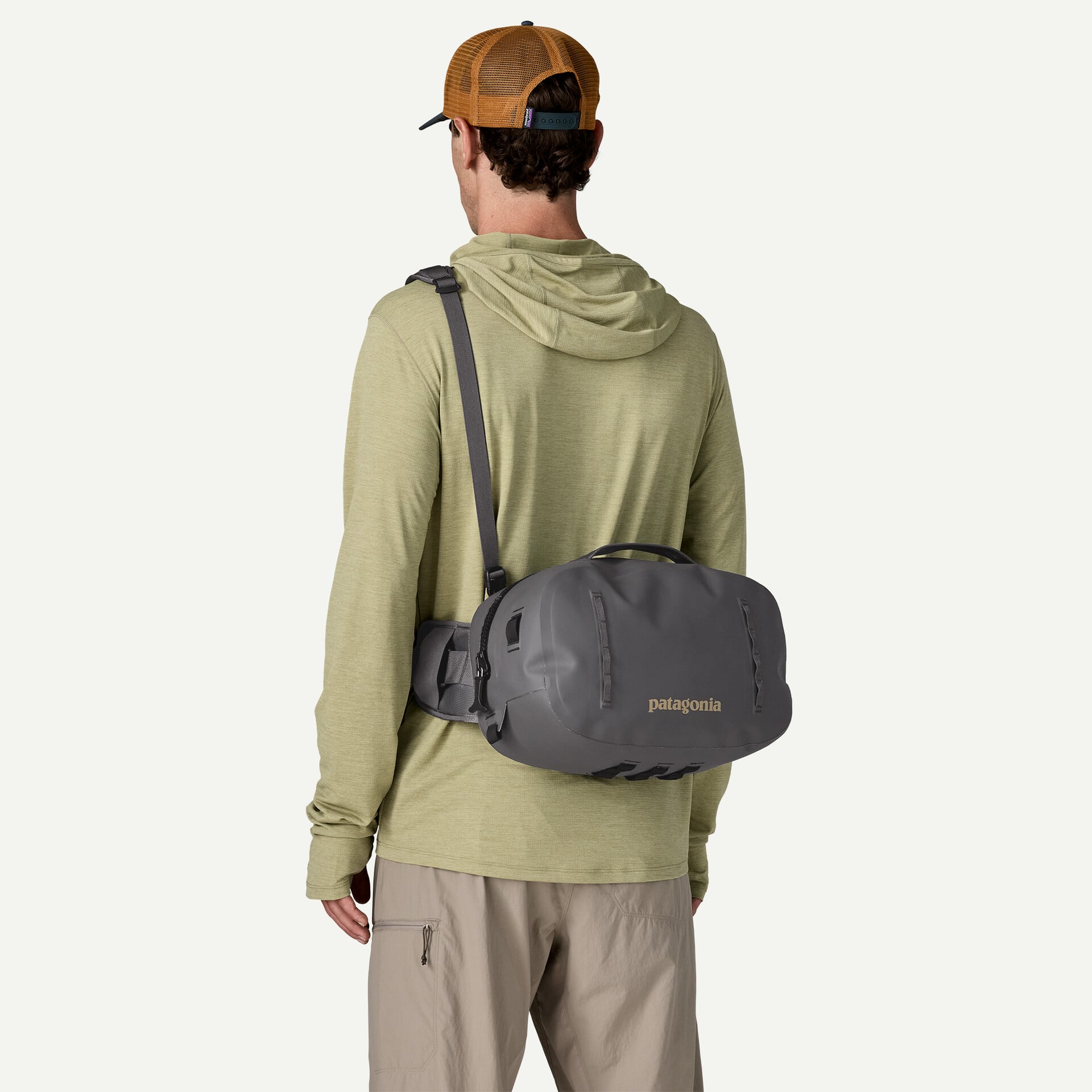 Rear view of Patagonia Guidewater Switch Pack in dark gray waterproof material, sling style with visible logo