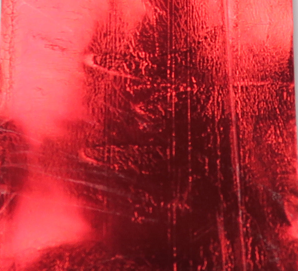 Red metallic Chocklett's Sili Skin sheet with glossy, scratched reflective surface for fly tying