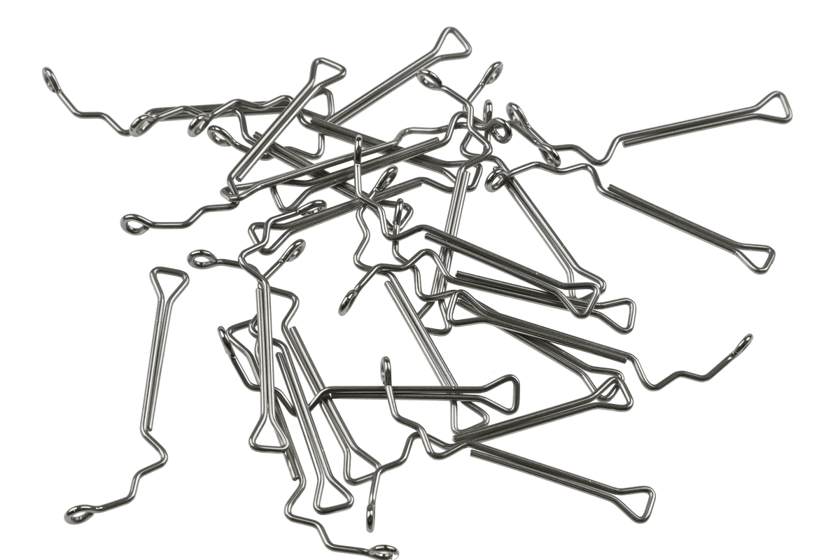 Pile of silver stainless steel Fish-Skull 60° articulated jig shanks with looped triangle ends and wavy shafts for fly tying