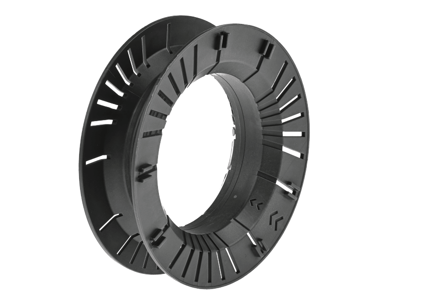 Black plastic Greys Pace cassette fly reel with ventilated slotted spool and open center hub, shown at an angle on a white