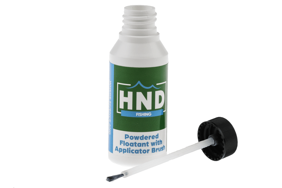 HND powdered floatant bottle with white body, green label, and black cap, with the applicator brush pulled out beside it