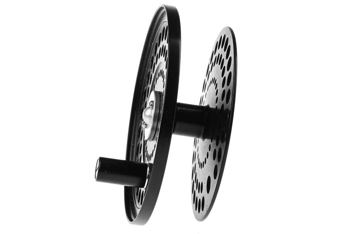 Orvis C.F.O black spare spool with perforated aluminum disc design and central arbor connection for fly fishing reel.