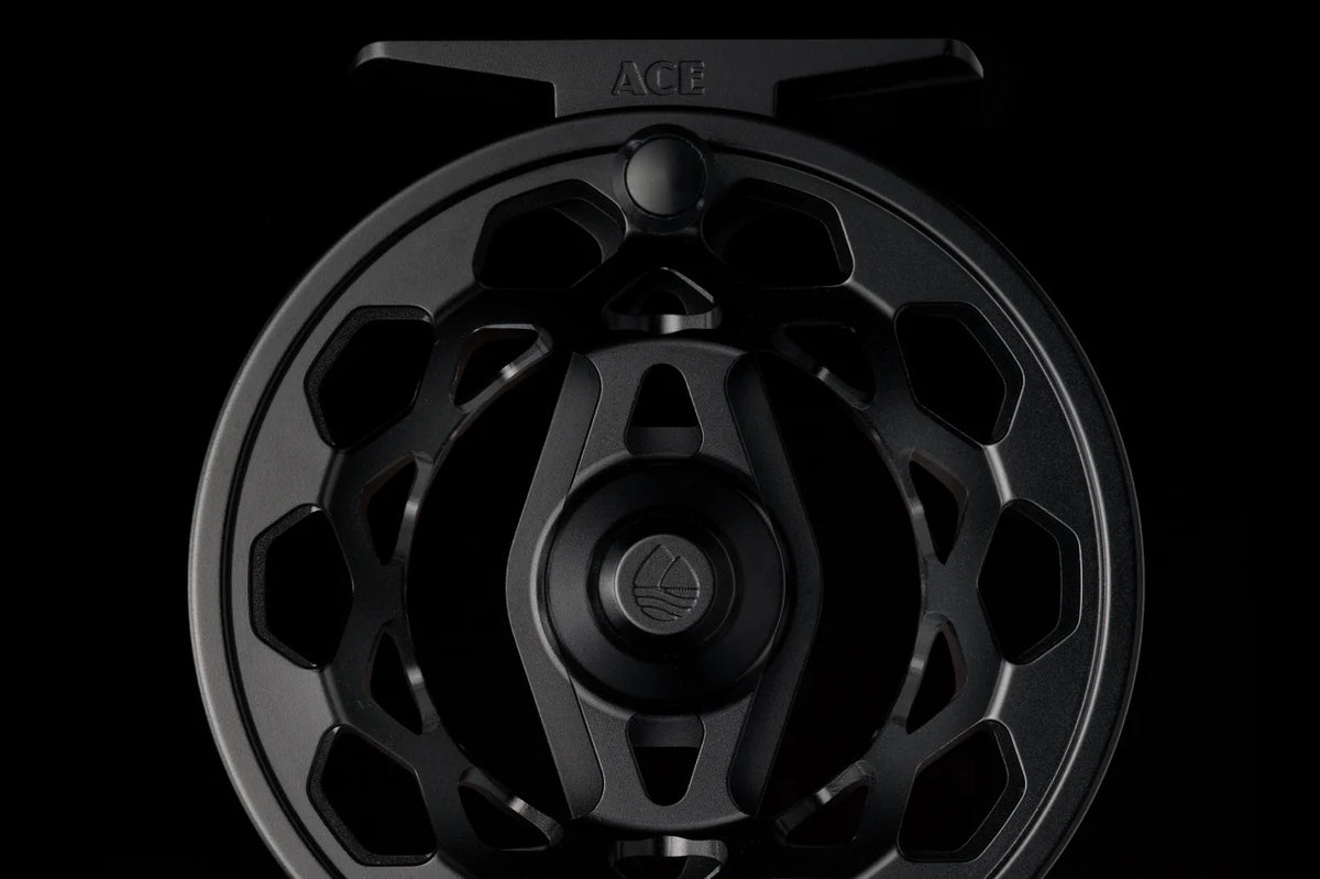 Redington Ace Tactical Edition black fly reel with large arbor design and skeletal frame on dark background