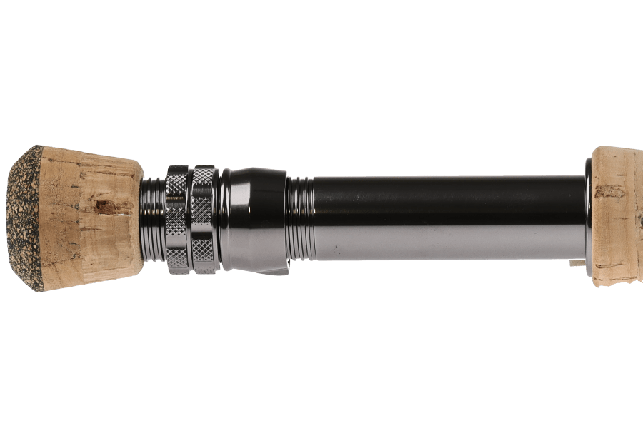TFO Legacy fly rod close-up showing natural cork grip with black gunmetal reel seat and dark graphite blank