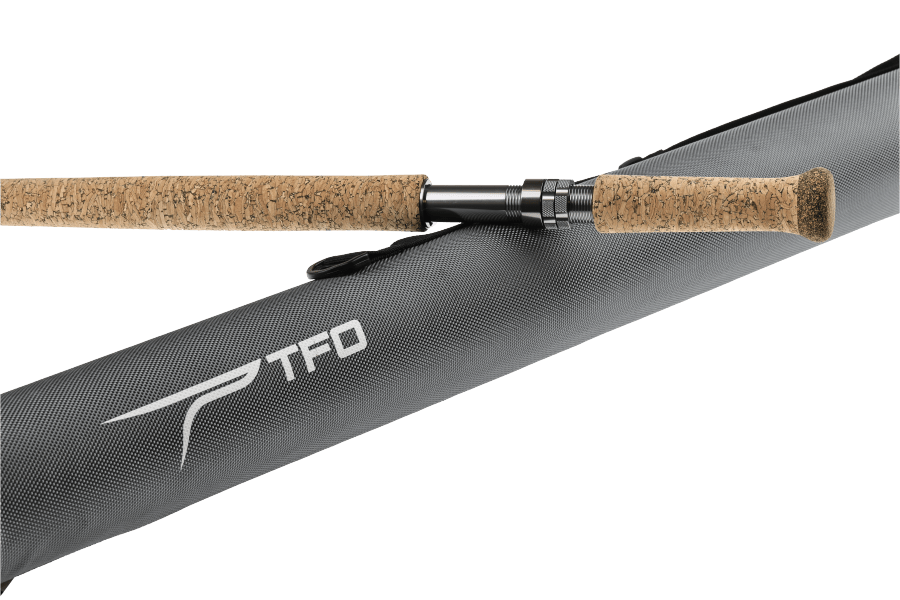 TFO two-handed fly rod with cork grips, black reel seat, and gray textured case, shown disassembled on a white background