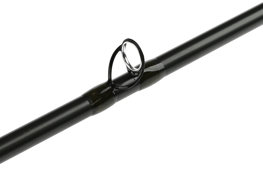 Black fly rod blank with a black snake guide and silver-ringed tip-top, wrapped in dark green thread accents, shown against