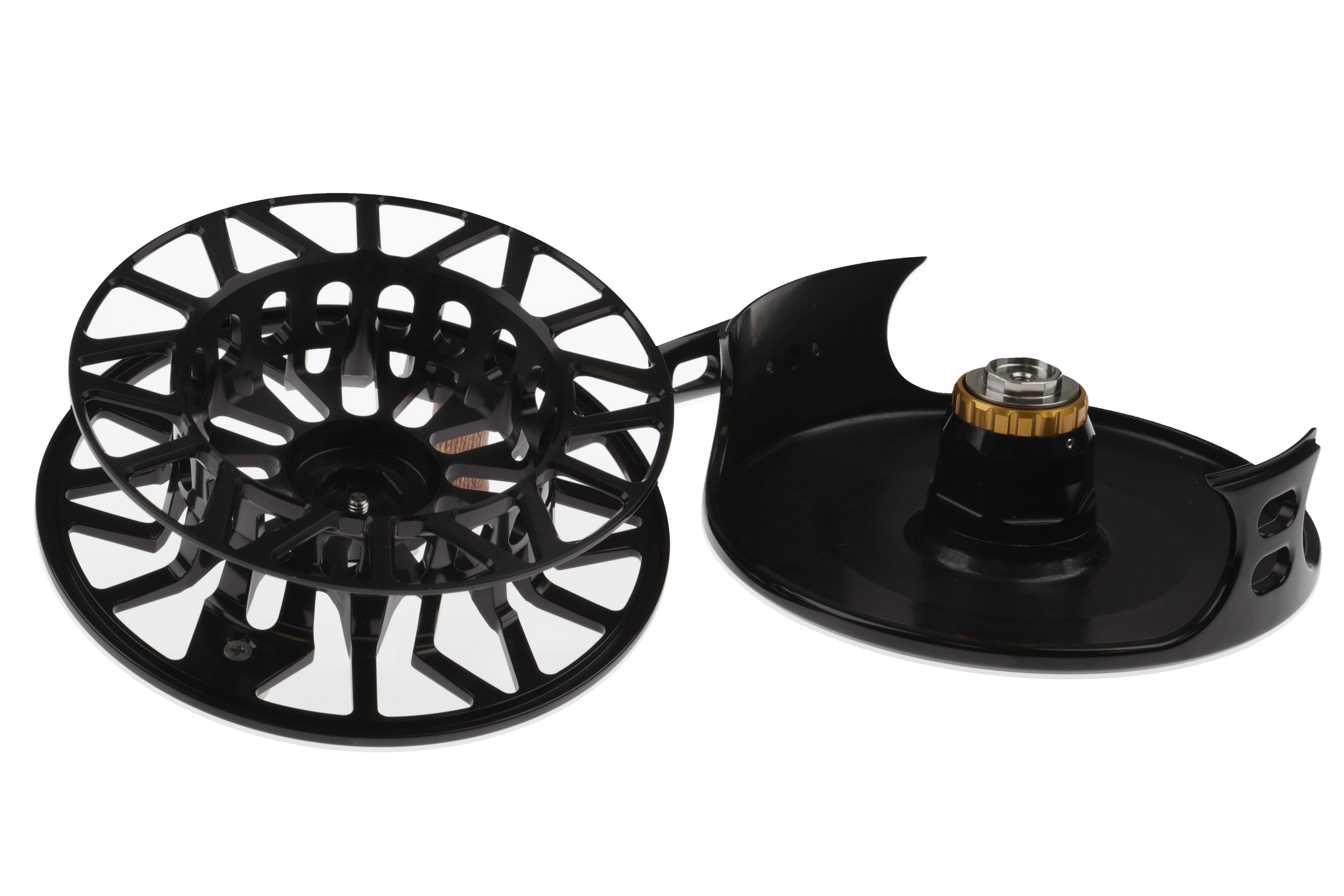 Abel SDS black anodized aluminum fly reel with skeletonized spool and gold drag knob, shown disassembled