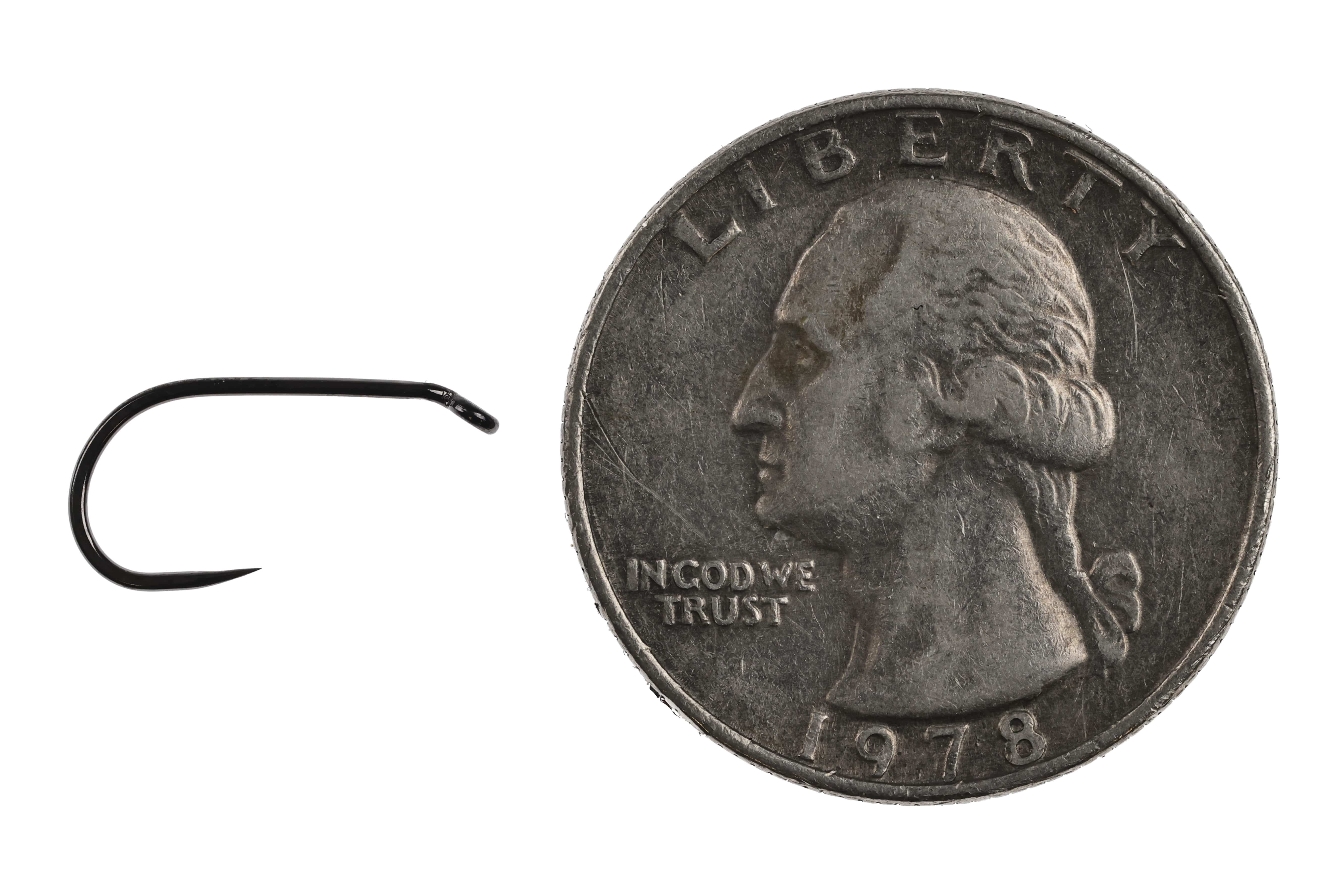 Black Ahrex AFW505 barbless short-shank steel dry fly hook with glossy finish shown next to US quarter for scale