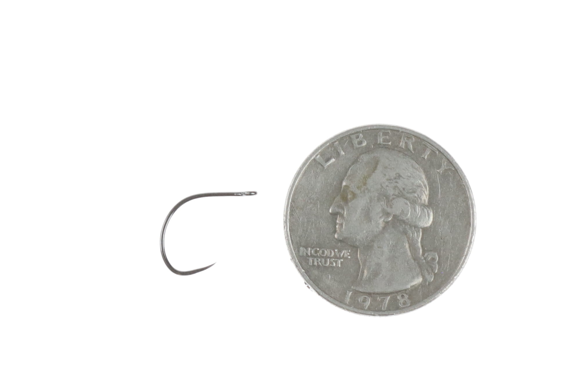 Ahrex big-gap short-shank dry fly hook in matte black nickel finish beside US quarter for scale
