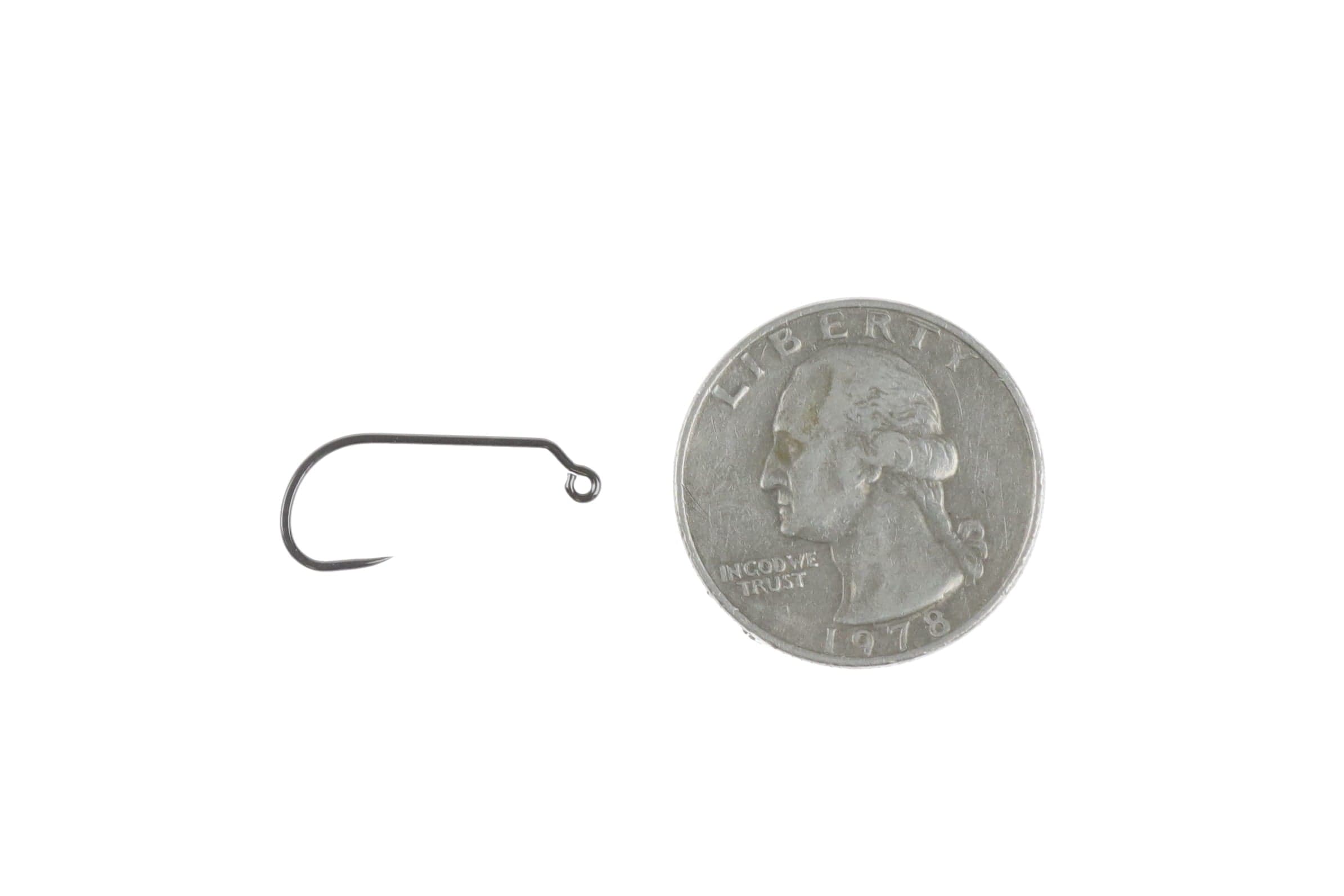 Gunmetal Ahrex mini jig hook with up-eye and angled point beside US quarter for scale, for fly tying