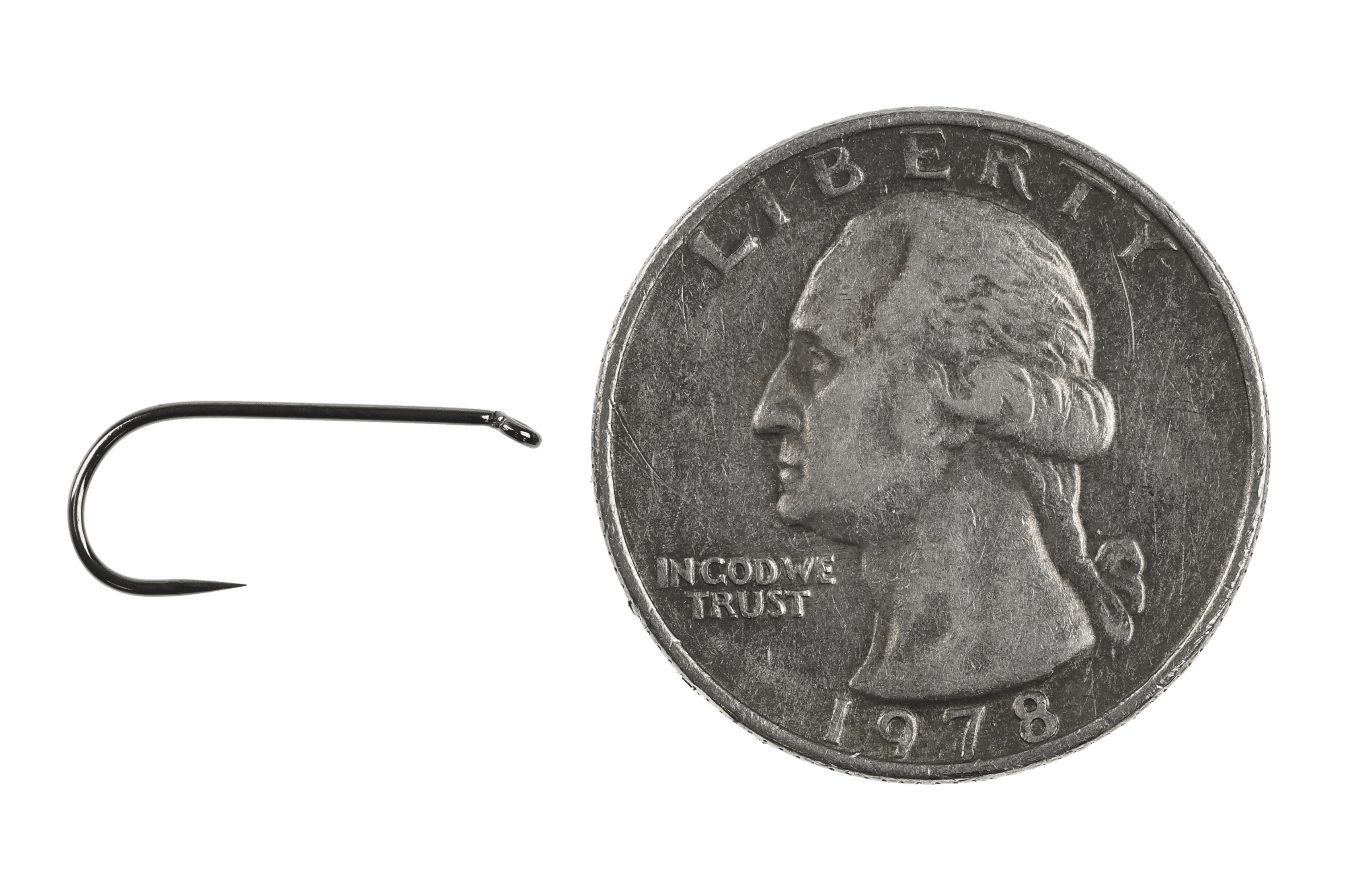 Ahrex FW501 barbless dry fly hook in dark gunmetal finish beside US quarter for scale, straight eye and curved shank