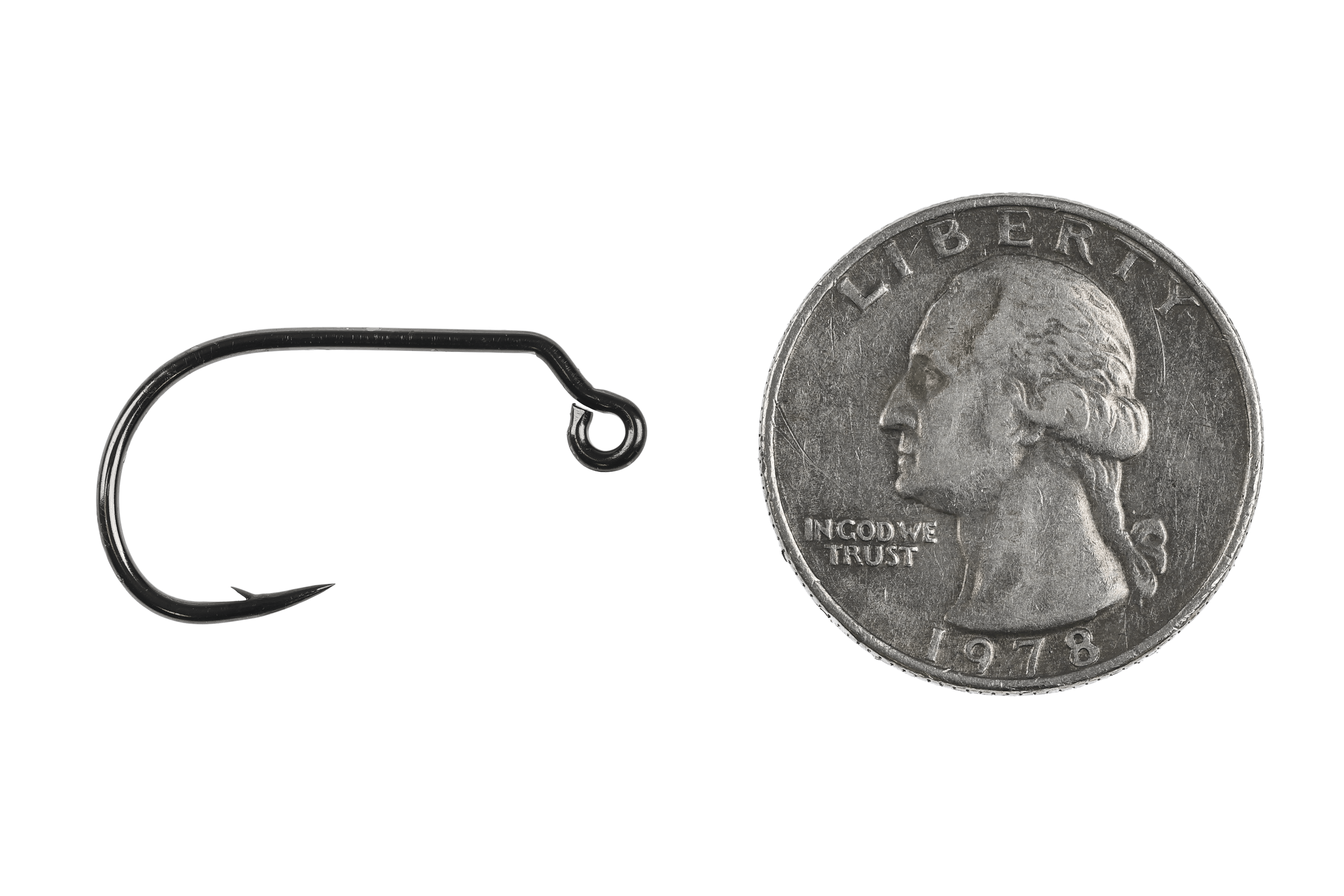 Black nickel Ahrex mini jig hook with up-eye, short bent shank and small barb beside US quarter for scale