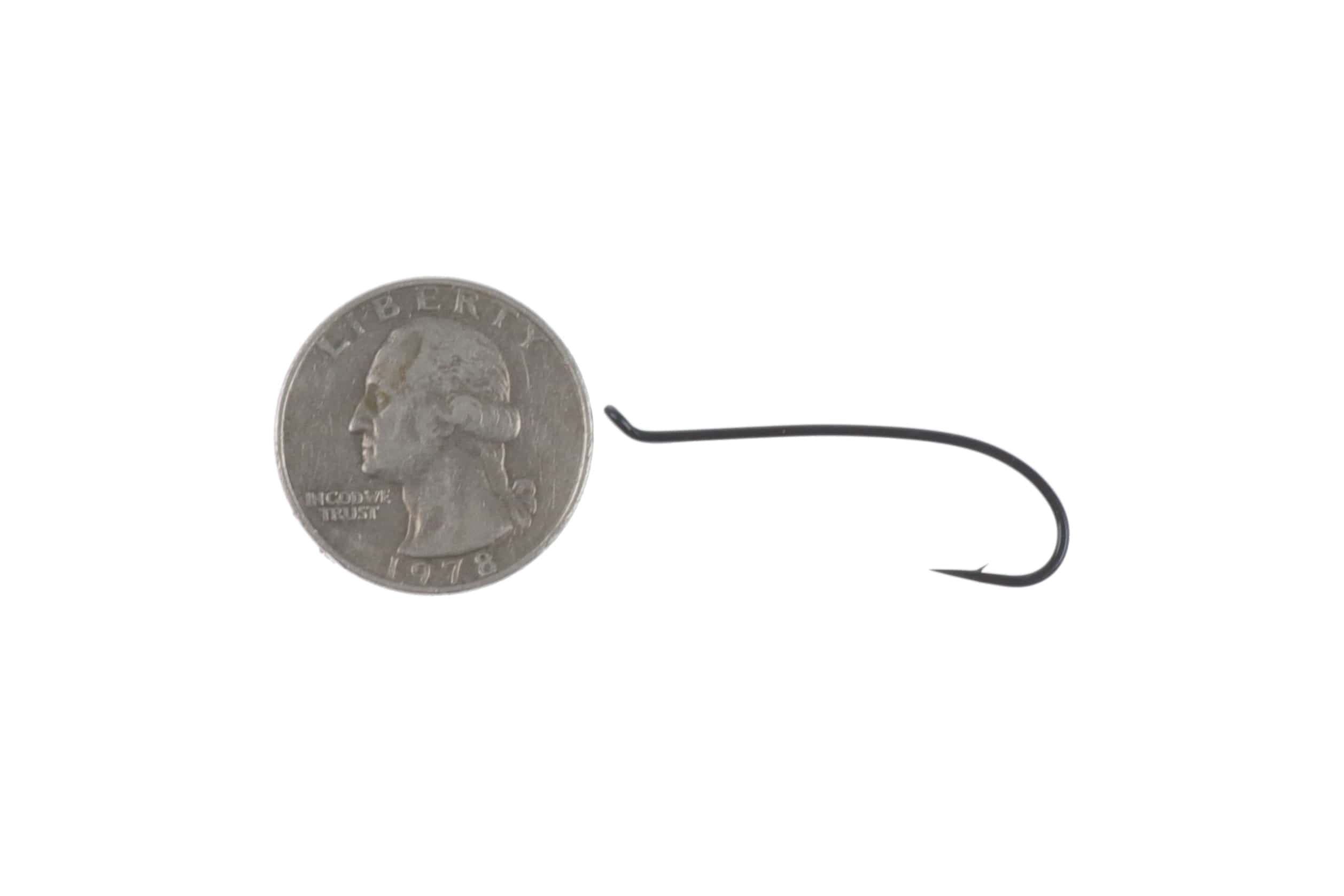 Matte black Ahrex HR412 low-water single salmon hook, curved short shank and upturned eye, shown next to US quarter for scale