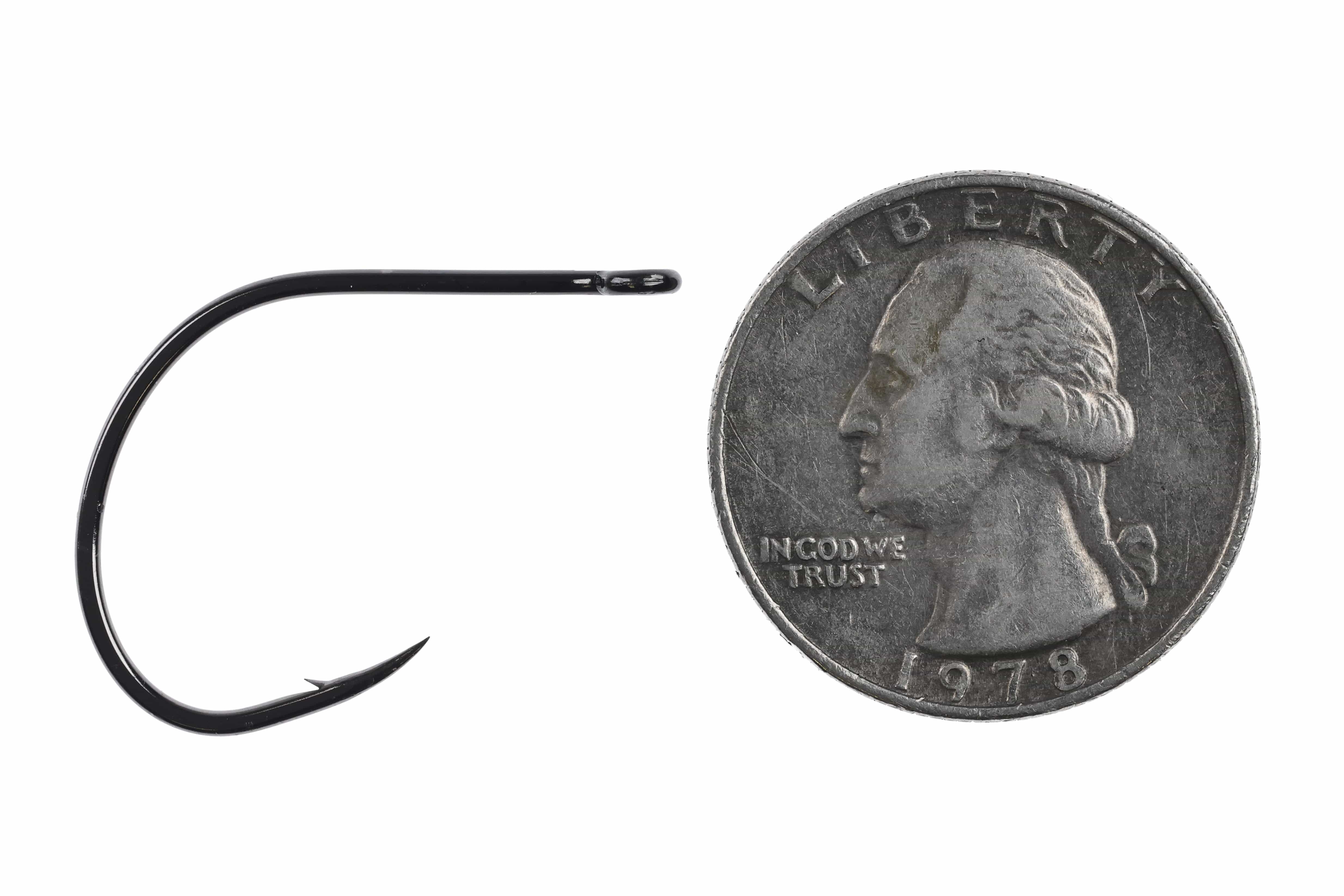 Black Ahrex NS172 Nordic Salt curved gammarus fly-tying hook with glossy finish and small barb beside US quarter for scale