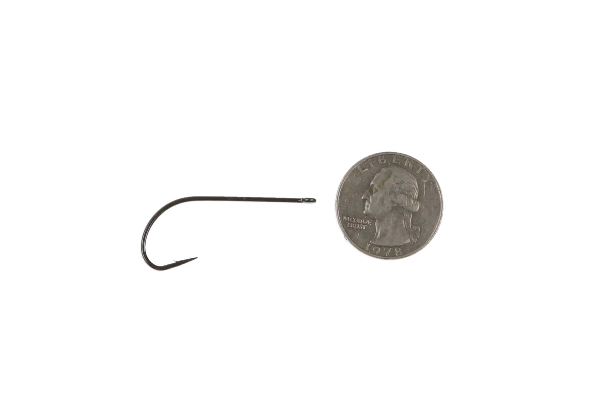 Ahrex PR320 black stinger hook with straight eye, curved shank and barbed point beside US quarter for scale, fly tying hook