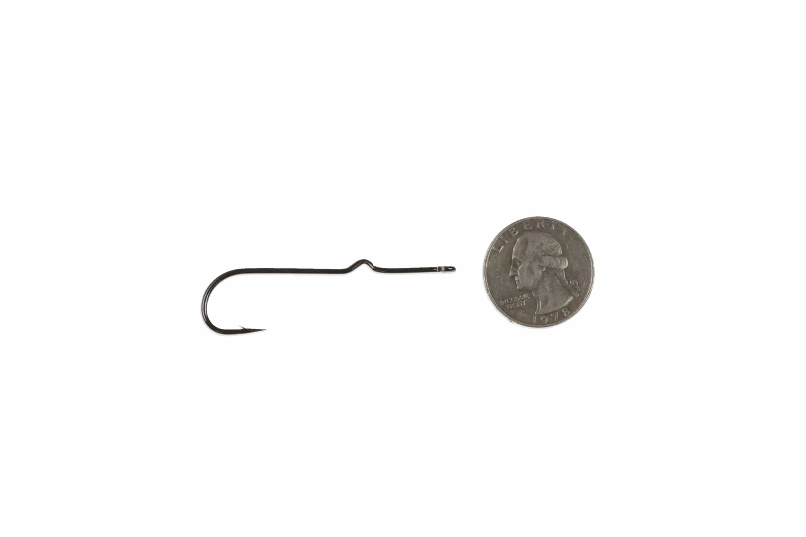Black nickel Ahrex long-shank popping/skip bug fly tying hook with kinked shank and sharp point beside US quarter for scale