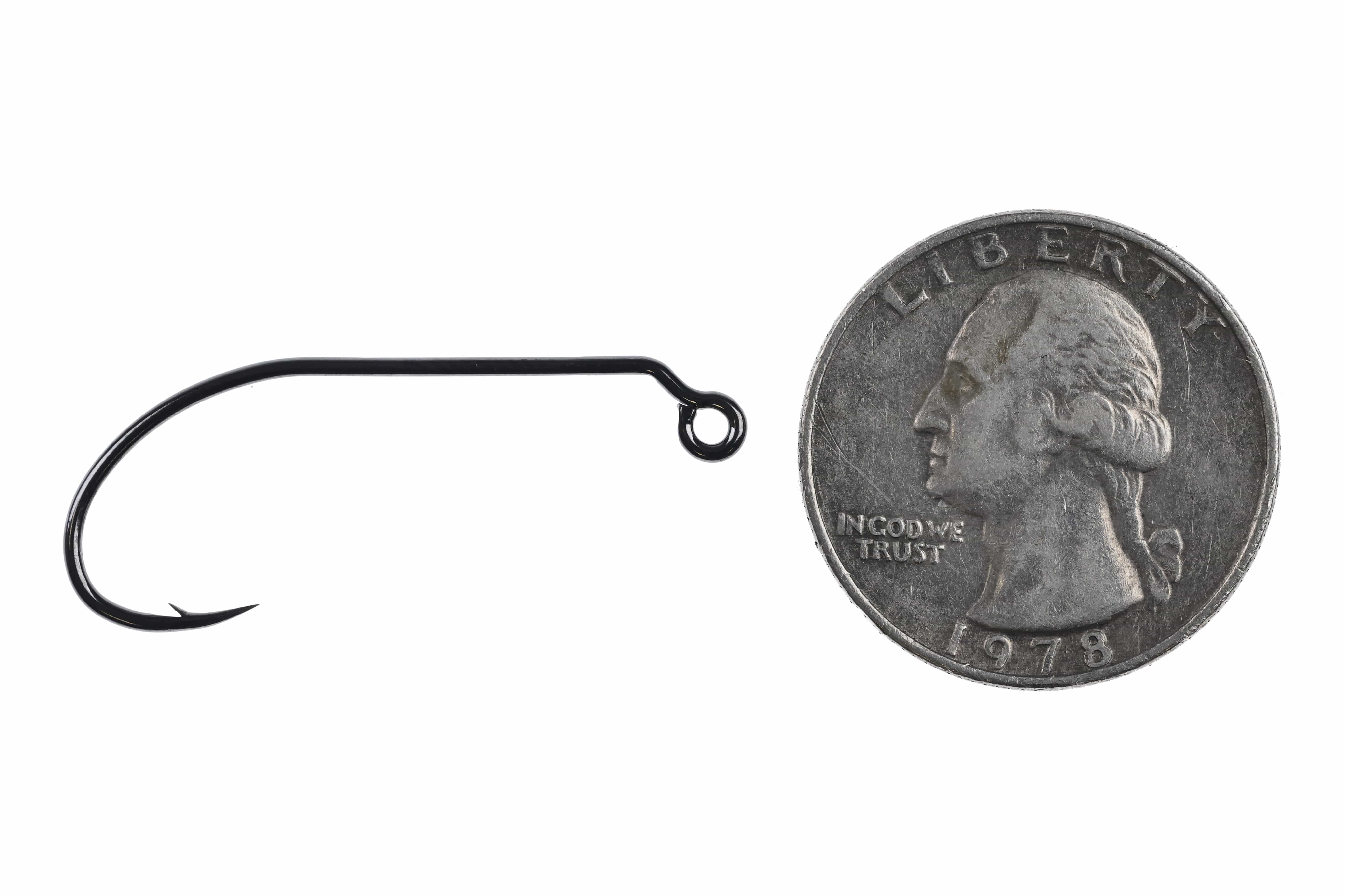 Black Ahrex PR360 50° jig hook, glossy finish with upturned eye and sharp barb beside US quarter for scale — fly tying