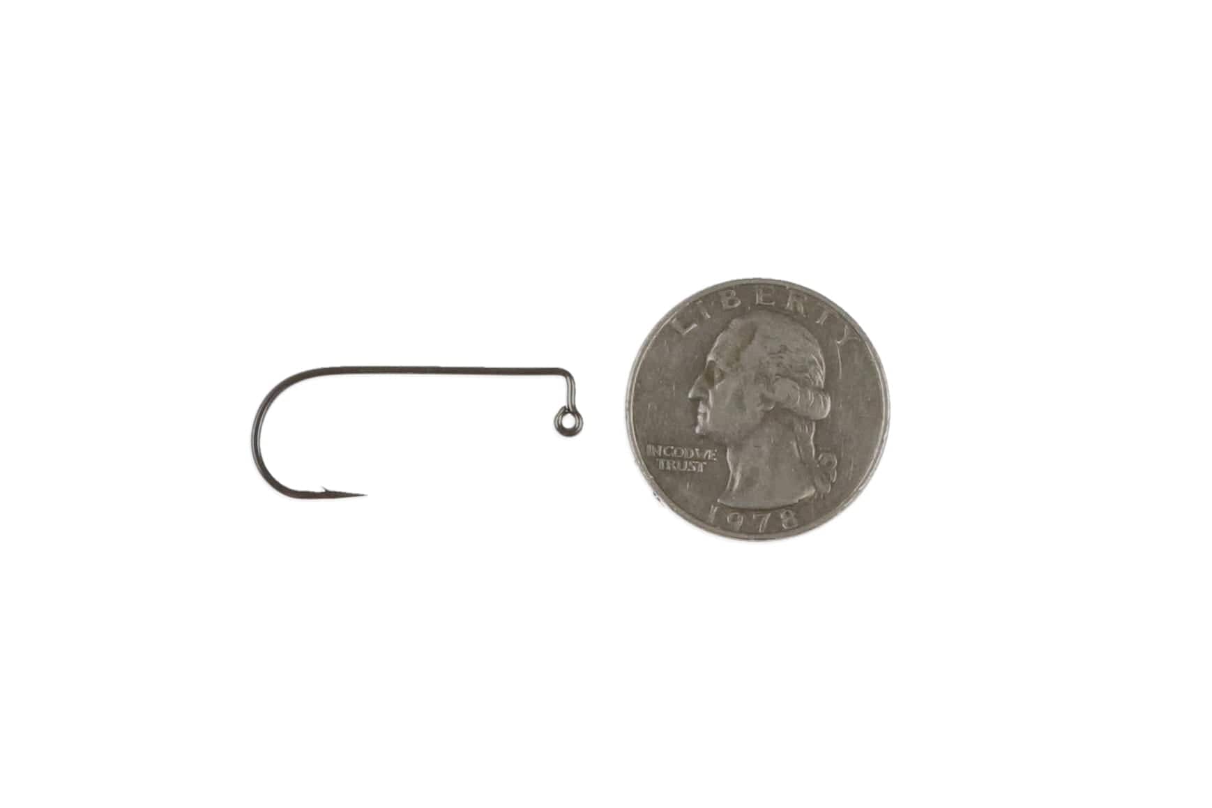 Ahrex PR374 90° black nickel jig hook for fly tying, dark steel curved shank and looped eye beside US quarter for scale