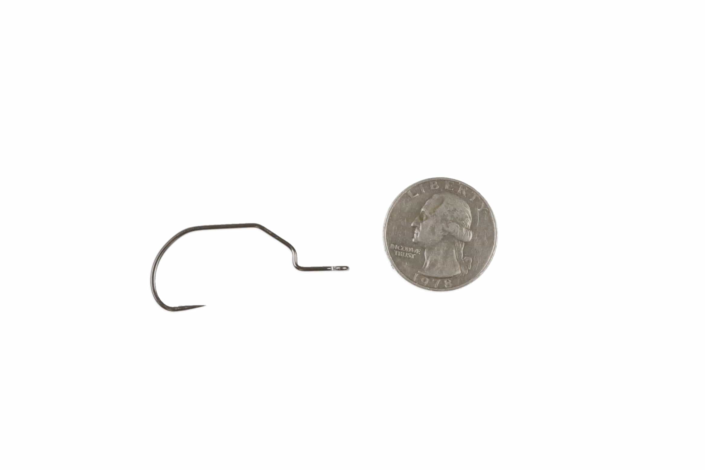 Ahrex PR378 GB gunmetal swimbait hook with wide gape and offset eye next to quarter for scale — fly tying
