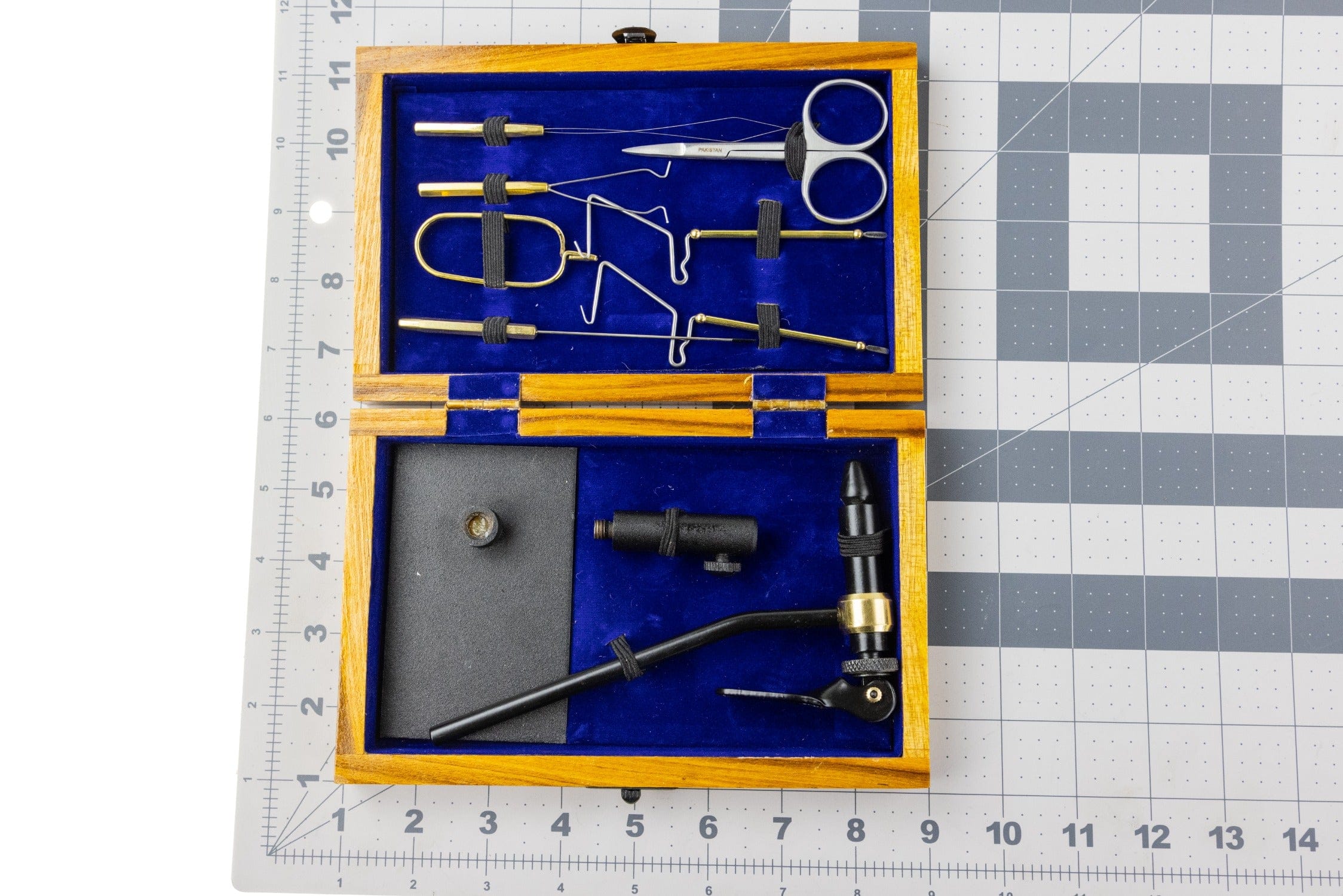 Wooden Angler Haus fly tying tool kit with blue velvet interior, brass and black pedestal vise and scissors
