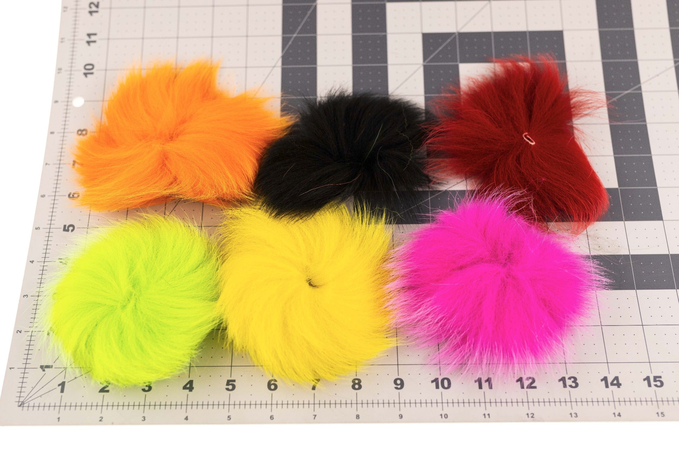 Six bright Blue Fox fur discs in orange, black, red, chartreuse, yellow and hot pink on grid, fly tying variety pack