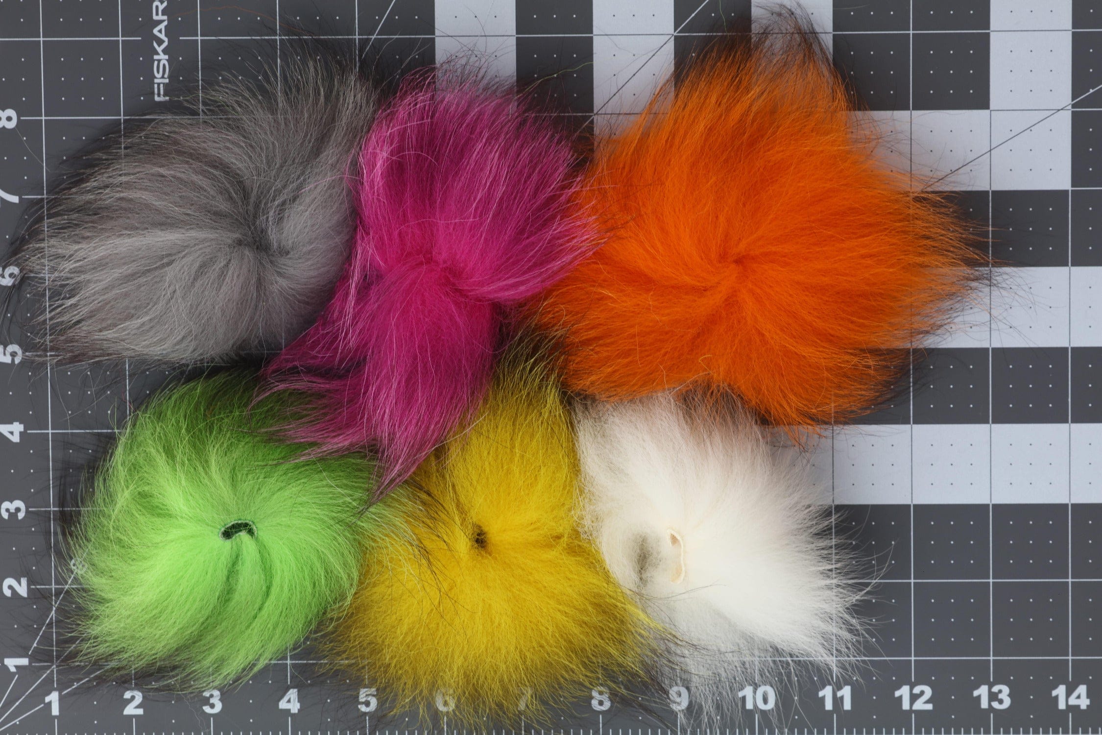 Assorted Arctic Fisherman mutation fox hair tufts in orange, fuchsia, chartreuse, gray, yellow and white for fly tying