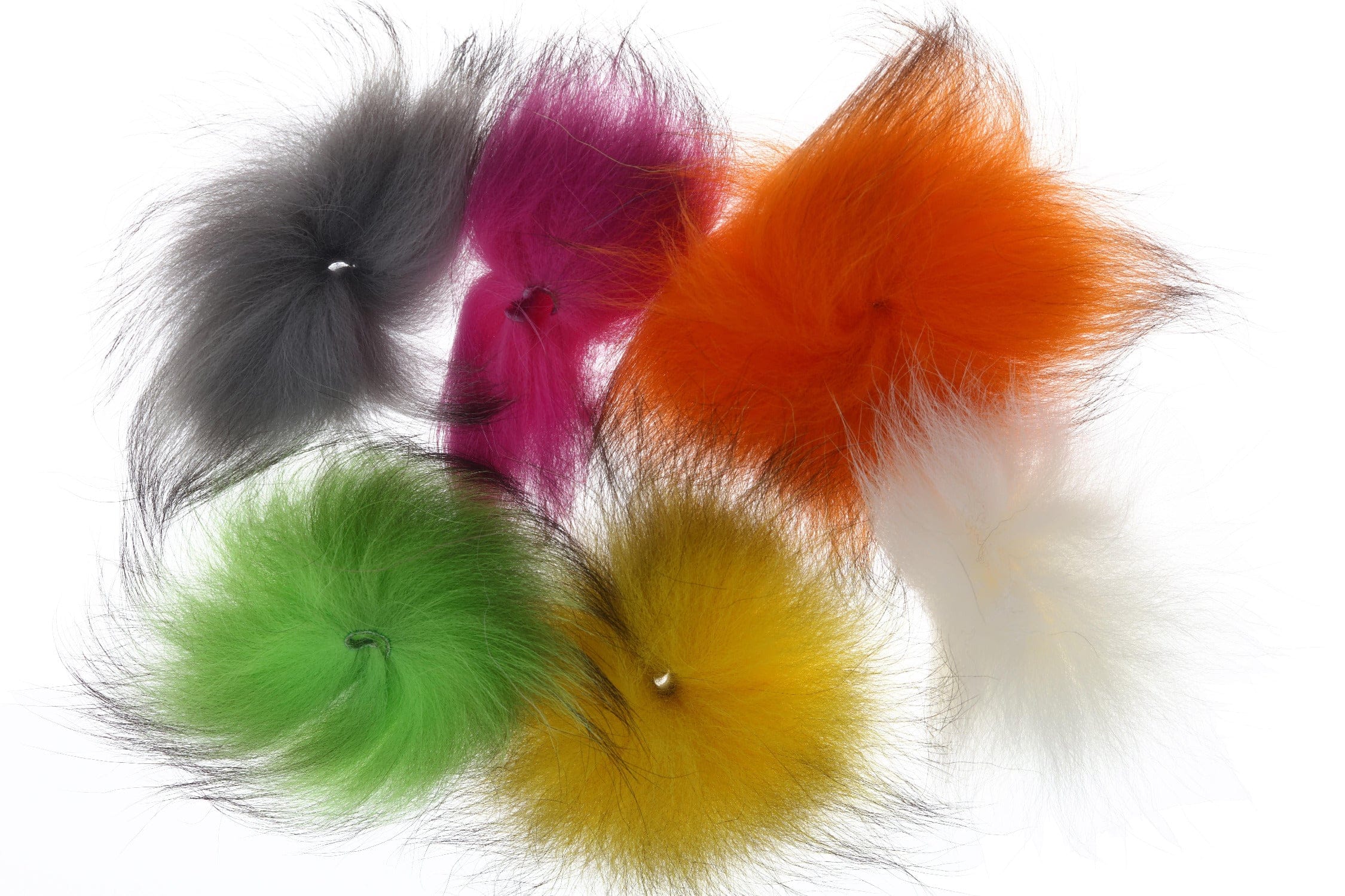Assorted dyed fox hair tufts for fly tying in gray, magenta, orange, green, yellow and white with wispy black tips