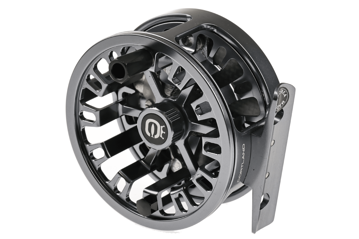 Cortland Retro Click fly reel in gunmetal gray with exposed mechanical components and classic design, displayed at angle
