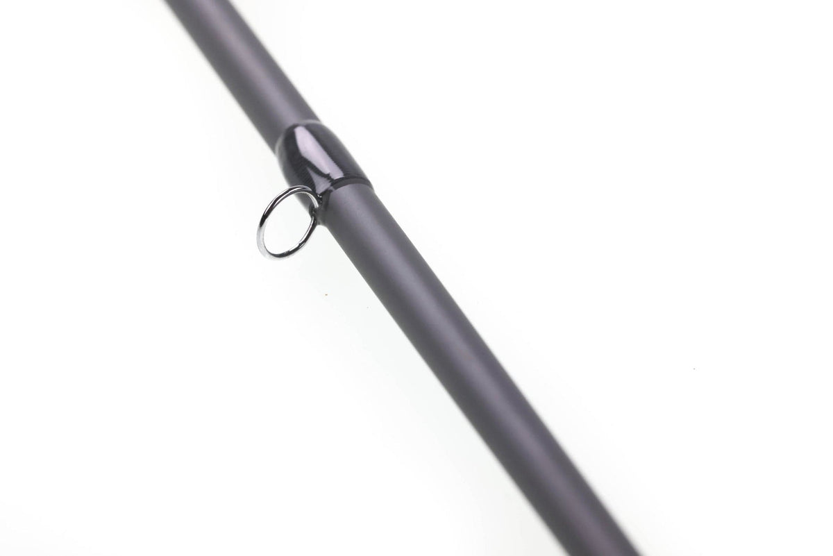 Douglas ERA fly rod close-up showing matte charcoal carbon fiber blank, glossy black thread wrap and chrome guide ring