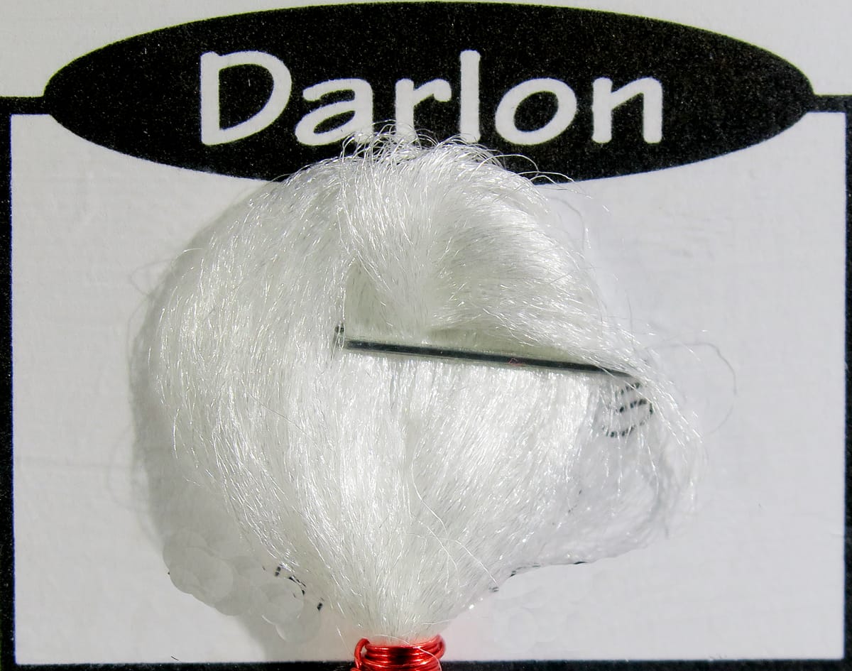 White Darlon synthetic fibers bundle with glossy strands and red-wrapped base on Ds Flyes fly tying card