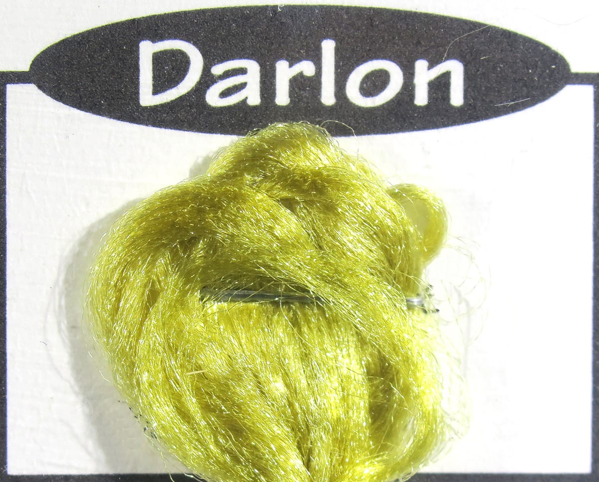 Shiny chartreuse Darlon synthetic fly tying fiber bundle with silky reflective strands on white card