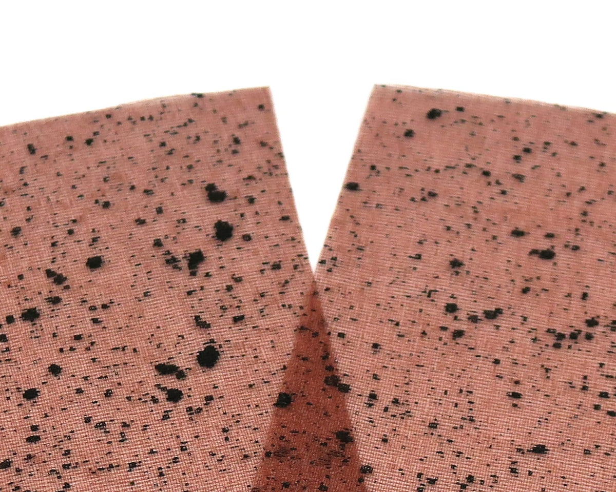 Salmon-pink mottled web wing material with black speckles, V-cut synthetic fabric for fly tying