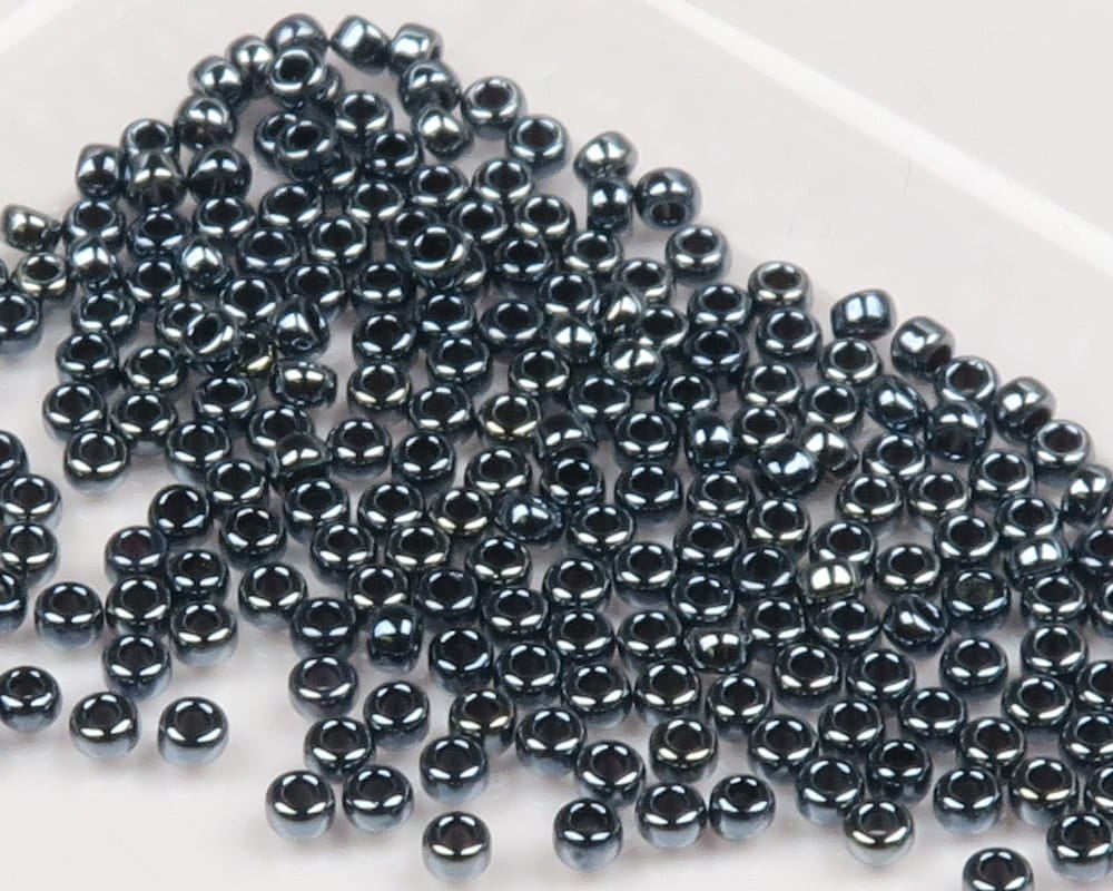 Shiny gunmetal glass beads with visible center holes, small glossy round fly tying beads for flies and lures