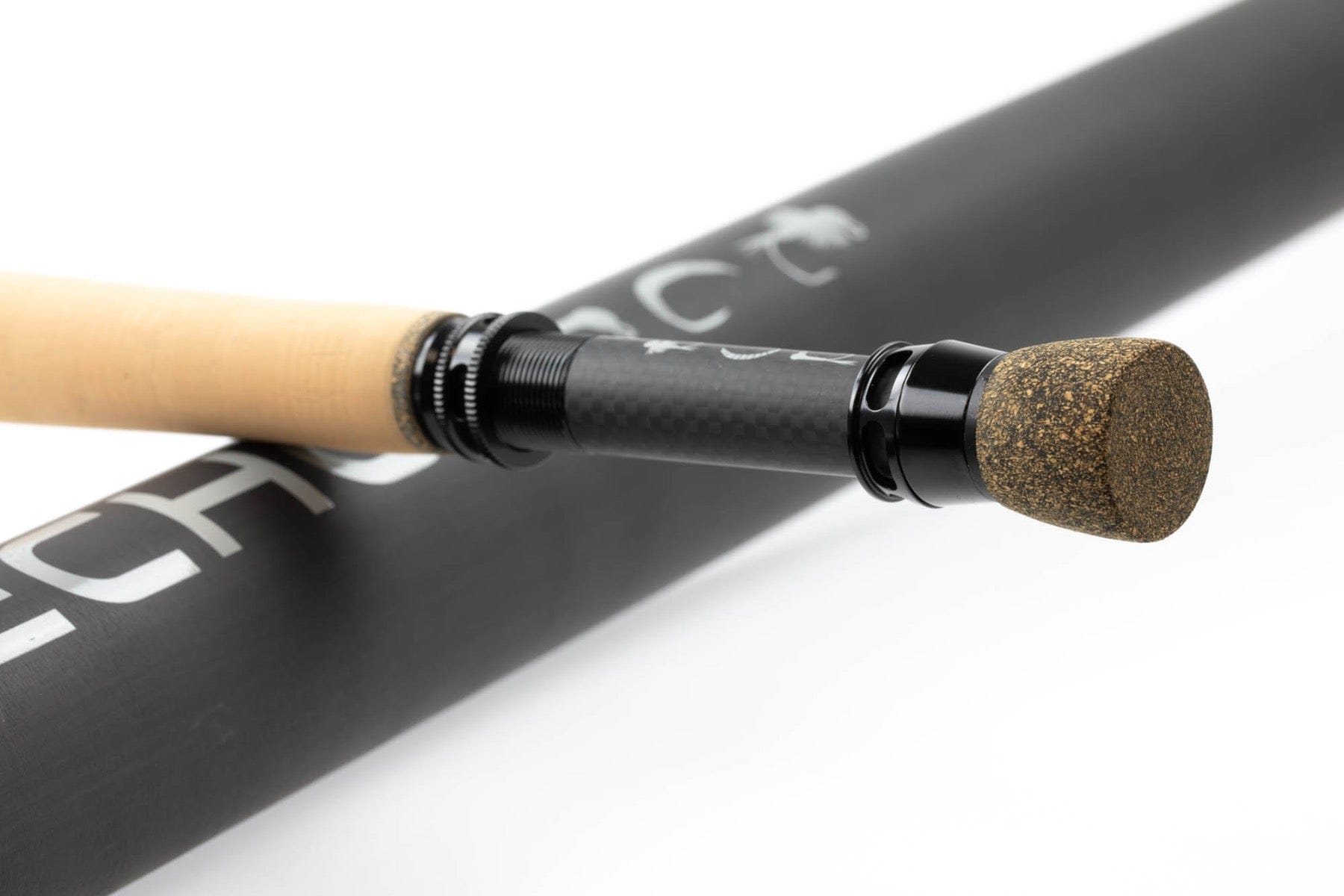 Echo Shadow X fly rod detail showing cork tail cap, black anodized reel seat and carbon fiber blank with matte Echo logo