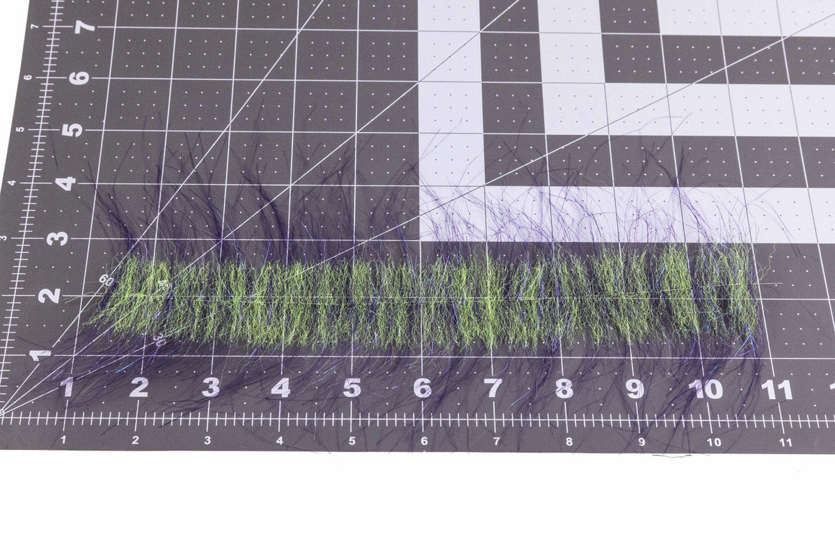 Enrico Puglisi craft fur strip with chartreuse-green synthetic base and long purple-black guard hairs on grid mat, fly tying