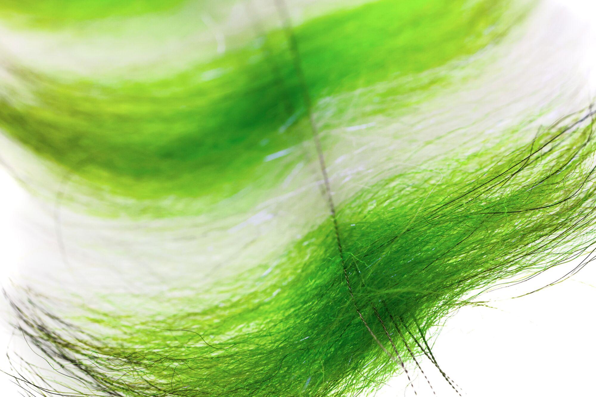 Bright chartreuse Grizzly Foxy synthetic fur with black guard hairs and subtle sparkle for fly tying brush