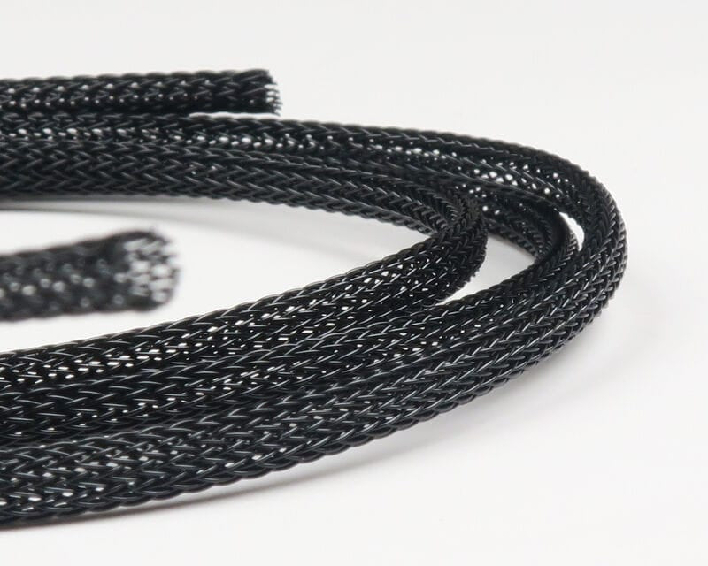 Black braided synthetic body tubing coil for fly tying with open mesh tubular weave