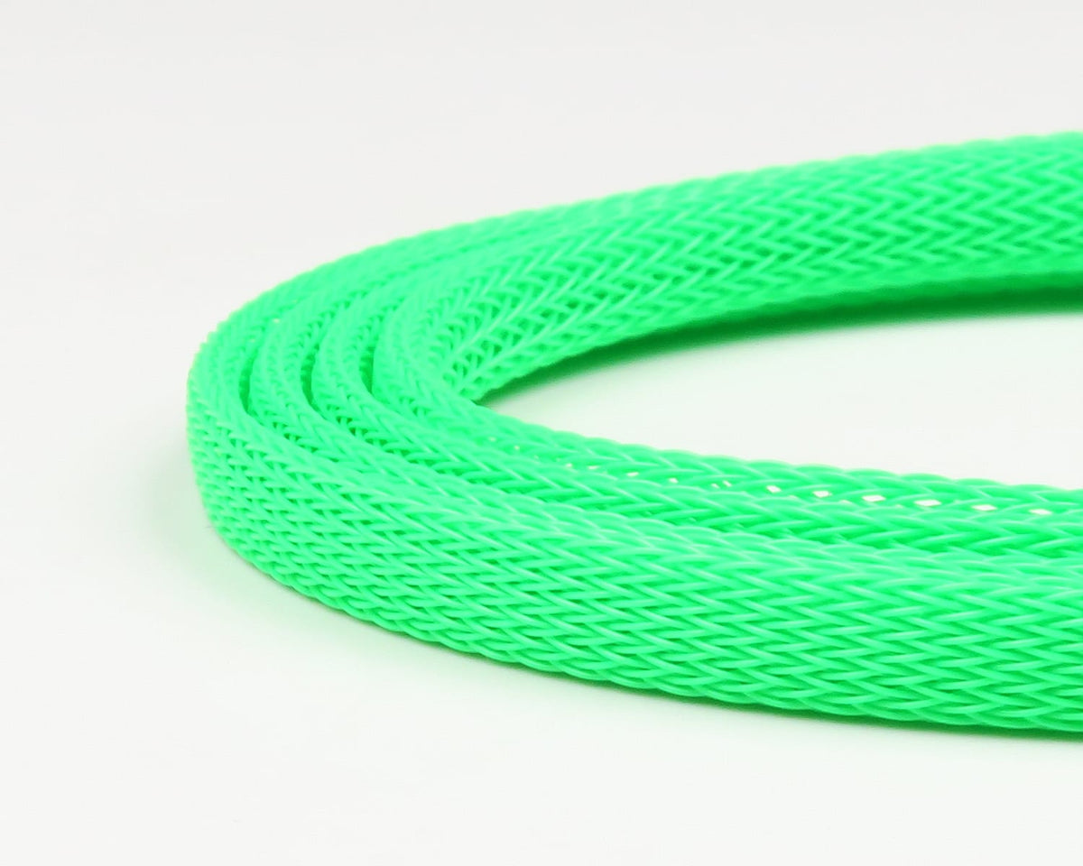 Neon green braided plastic body tubing for fly tying with woven mesh texture, flexible tubular material