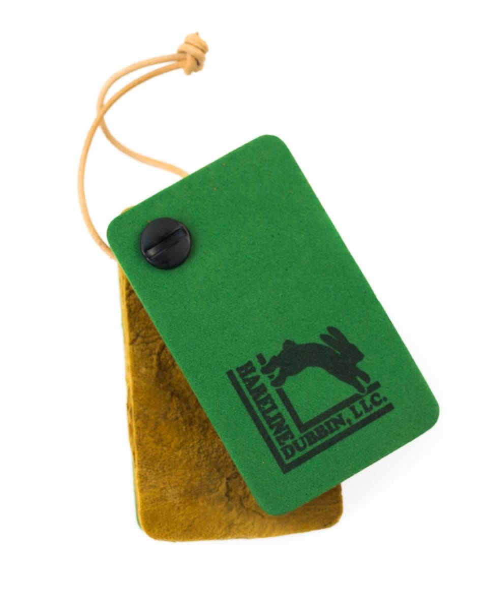 Green foam amadou dryer with black Hareline rabbit logo, tan suede backing and leather cord loop