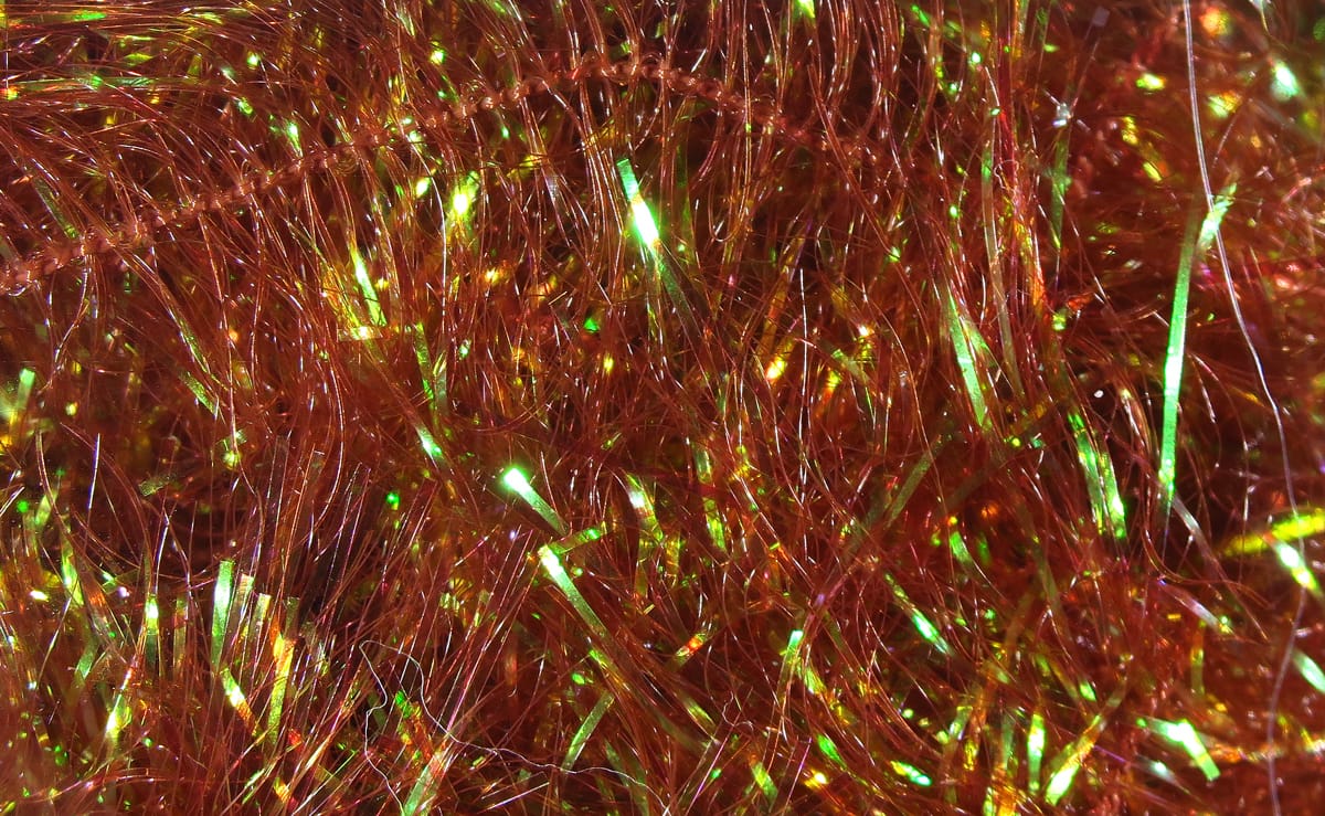 Copper-orange iridescent synthetic filler flash fibers with green reflective highlights, shaggy fly tying material