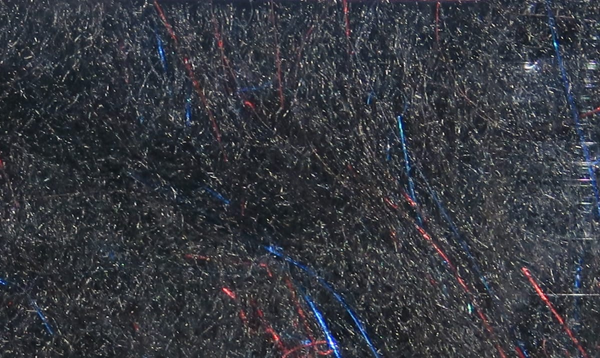 Charcoal synthetic fly tying dubbing with fine fibers and red and blue iridescent flash strands, Hareline Bruiser Blend