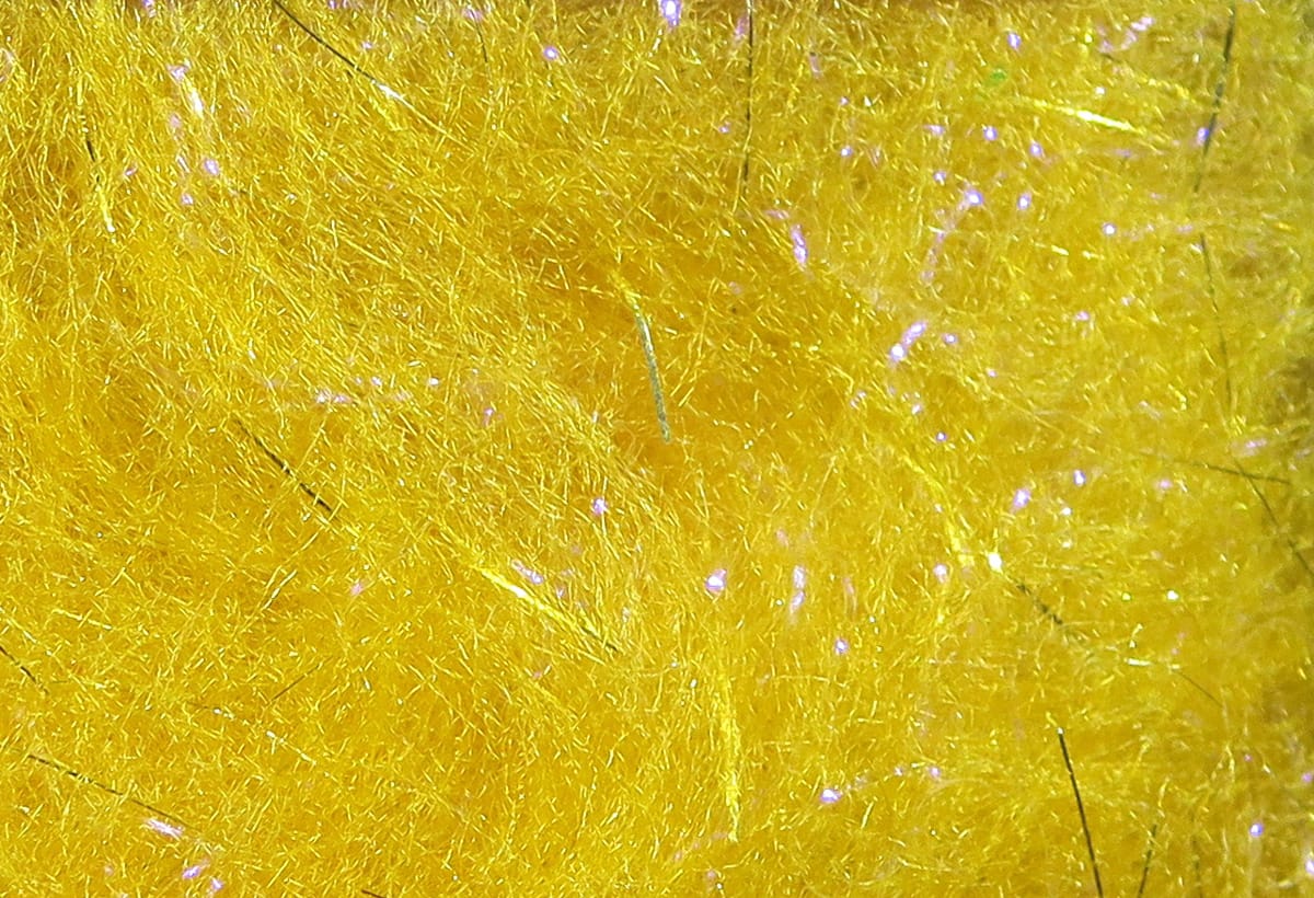 Bright yellow Bruiser Blend synthetic dubbing with fine fibers and iridescent flash, fly tying material close-up