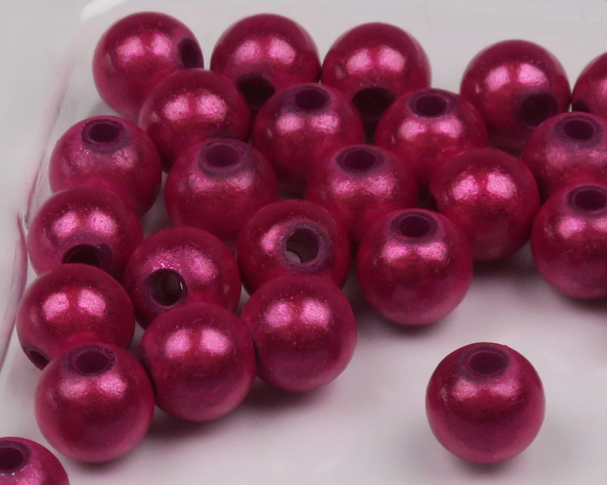 Magenta metallic round Hareline 3D beads with pearlescent finish and center holes for fly tying