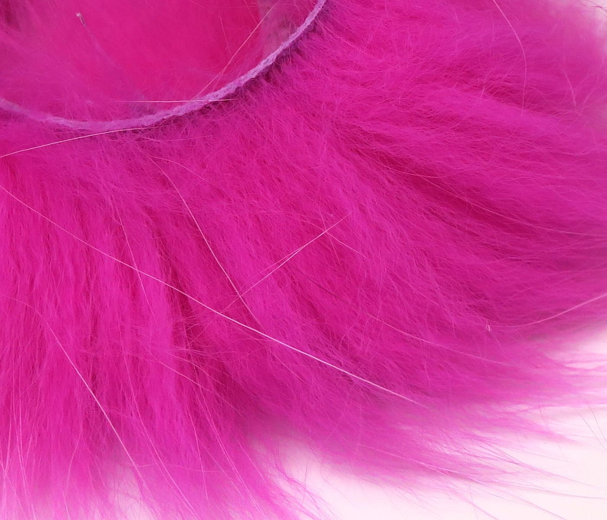 Bright fuchsia Arctic Fox zonker strips with long soft fur, leather strip backing and pale guard hairs for fly tying