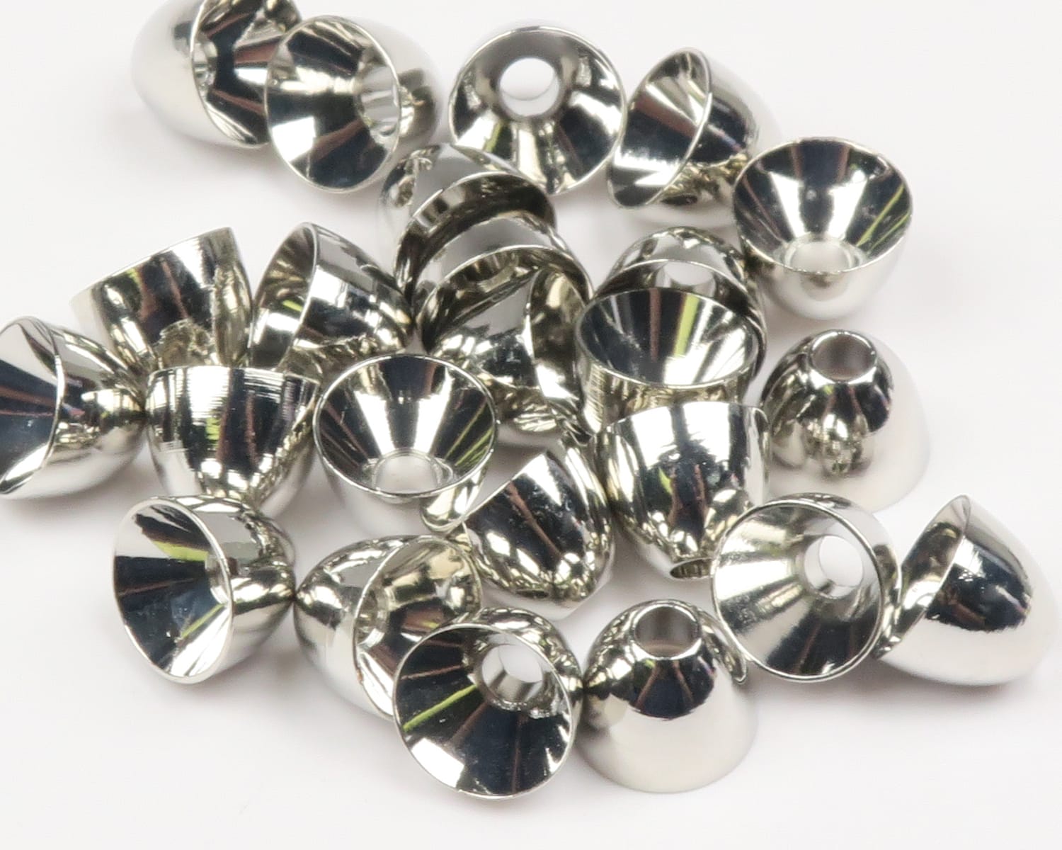 Hareline shiny brass cone heads for fly tying, reflective silver-colored conical metal heads with center holes