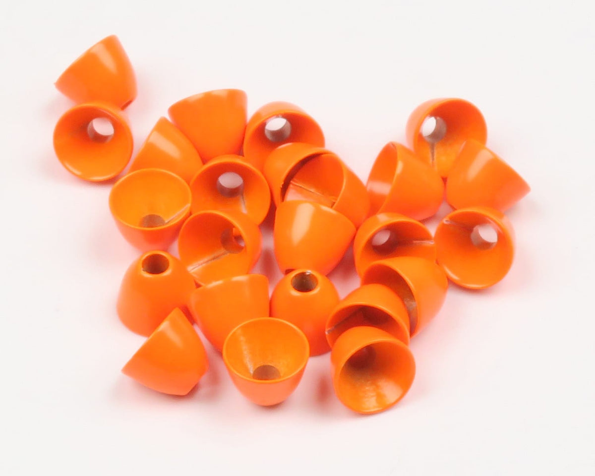Bright orange painted brass cone heads with center holes, small conical fly tying beads scattered on white background