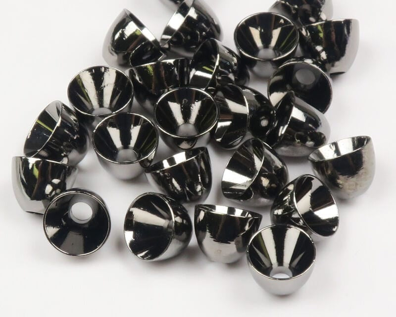 Shiny gunmetal brass cone heads with center holes, cone-shaped fly tying beads scattered on white background