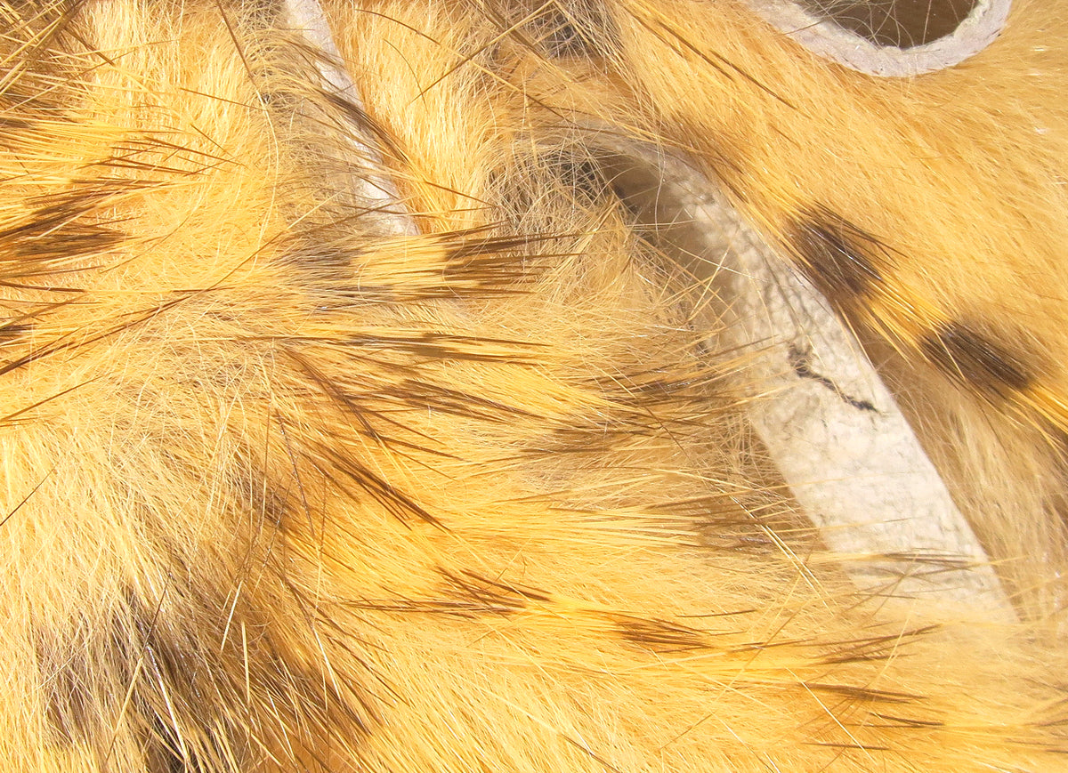 Hareline brown barred rabbit fur strips, golden-brown fur with dark barred guard hairs on suede backing for fly tying