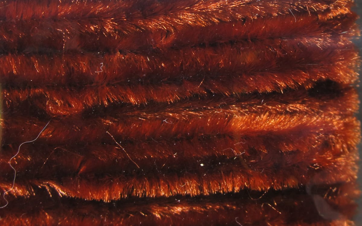 Copper brown Hareline chenille with fuzzy, shiny fibers and metallic highlights, close-up rows for fly tying