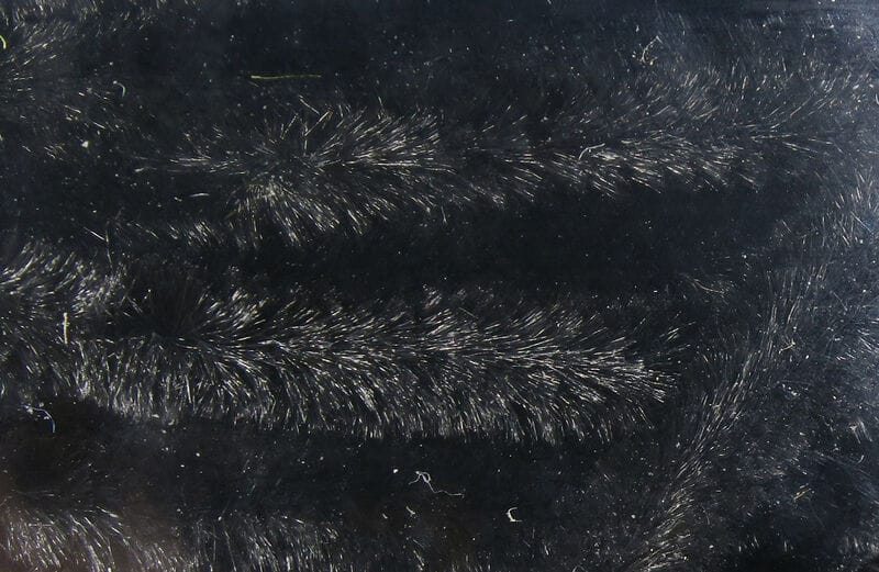 Black Hareline chenille with silver flash fibers, fuzzy synthetic yarn for fly tying